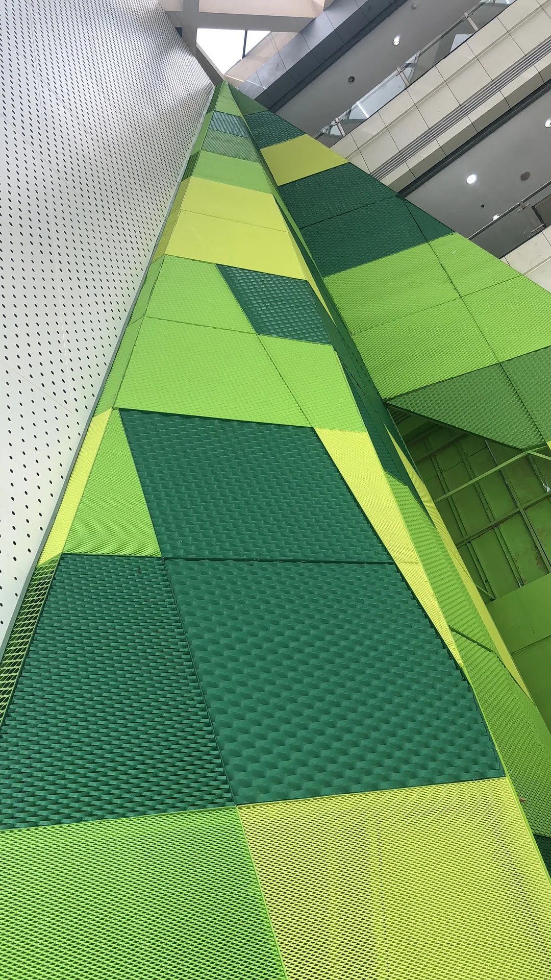 Faceted green expanded metal facade